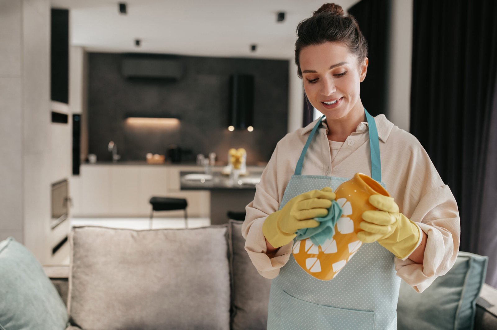 cleaning crockery woman gloves cleaning orange vase scaled