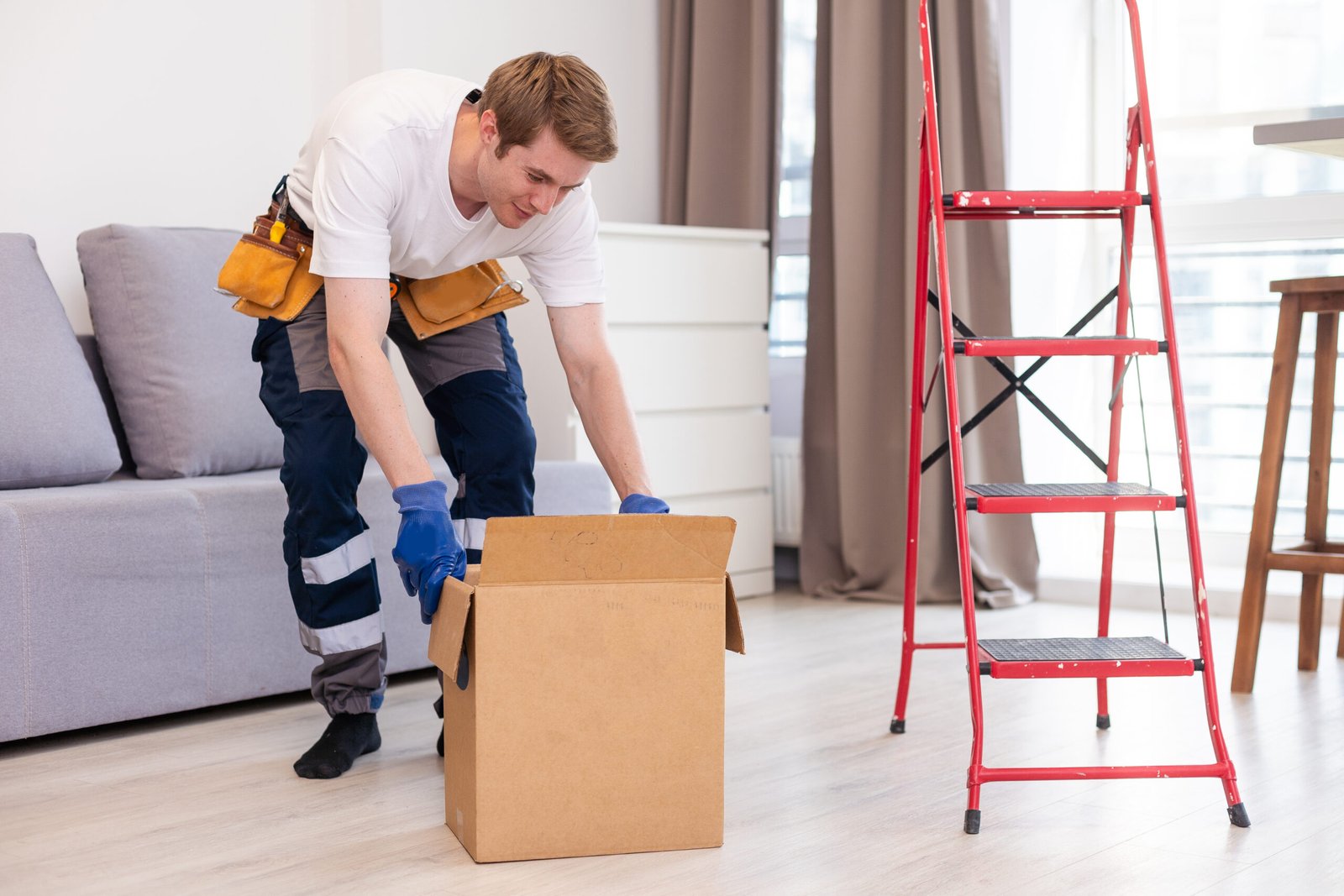man moving cardboard box with ladder indoors 2026 01 07 06 22 04 utc scaled